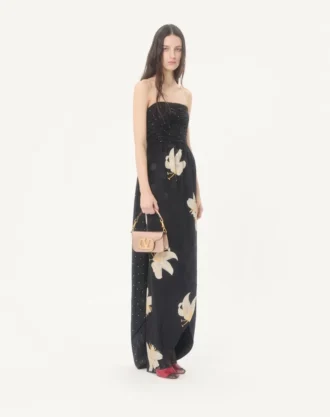 Bolso bandolera pequeño Valentino Garavani Locò en piel de becerro laminada con logotipo joya