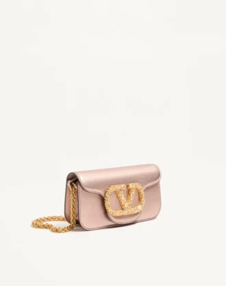 Bolso bandolera pequeño Valentino Garavani Locò en piel de becerro laminada con logotipo joya