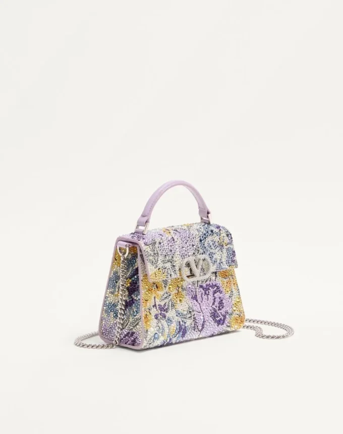 Bolso de mano mini Valentino Garavani Vsling con motivo Flowerism de pedrería y logotipo joya Bolso de mano mini Valentino Garavani Vsling con motivo Flowerism de pedrería y logotipo joya