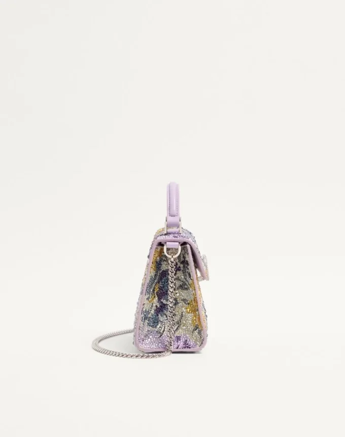 Bolso de mano mini Valentino Garavani Vsling con motivo Flowerism de pedrería y logotipo joya Bolso de mano mini Valentino Garavani Vsling con motivo Flowerism de pedrería y logotipo joya