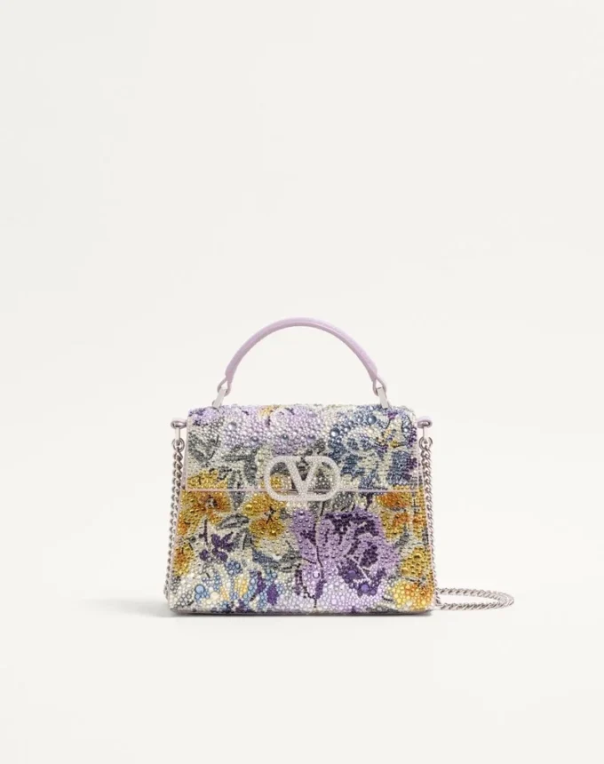 Bolso de mano mini Valentino Garavani Vsling con motivo Flowerism de pedrería y logotipo joya Bolso de mano mini Valentino Garavani Vsling con motivo Flowerism de pedrería y logotipo joya