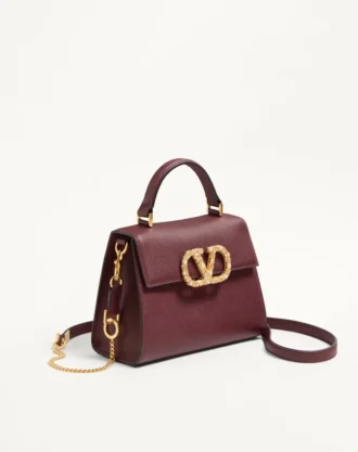Bolso pequeño Valentino Garavani Vsling en piel de becerro granulada con logotipo joya