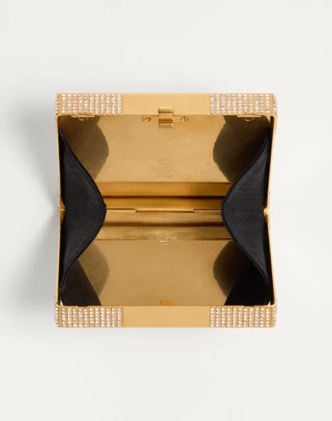 Minaudière Minaumorphe de Valentino Garavani en metal con cristales Swarovski® y estuche de satén