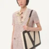 Vestido corto de tweed con cinta bordada